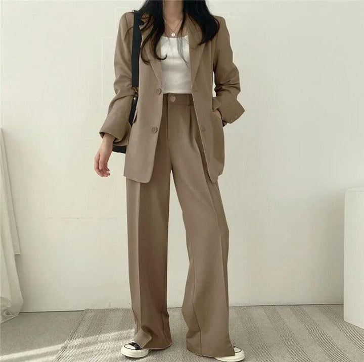 Modern office wear: women's elegant suit with a long tailored blazer and sleek trousers