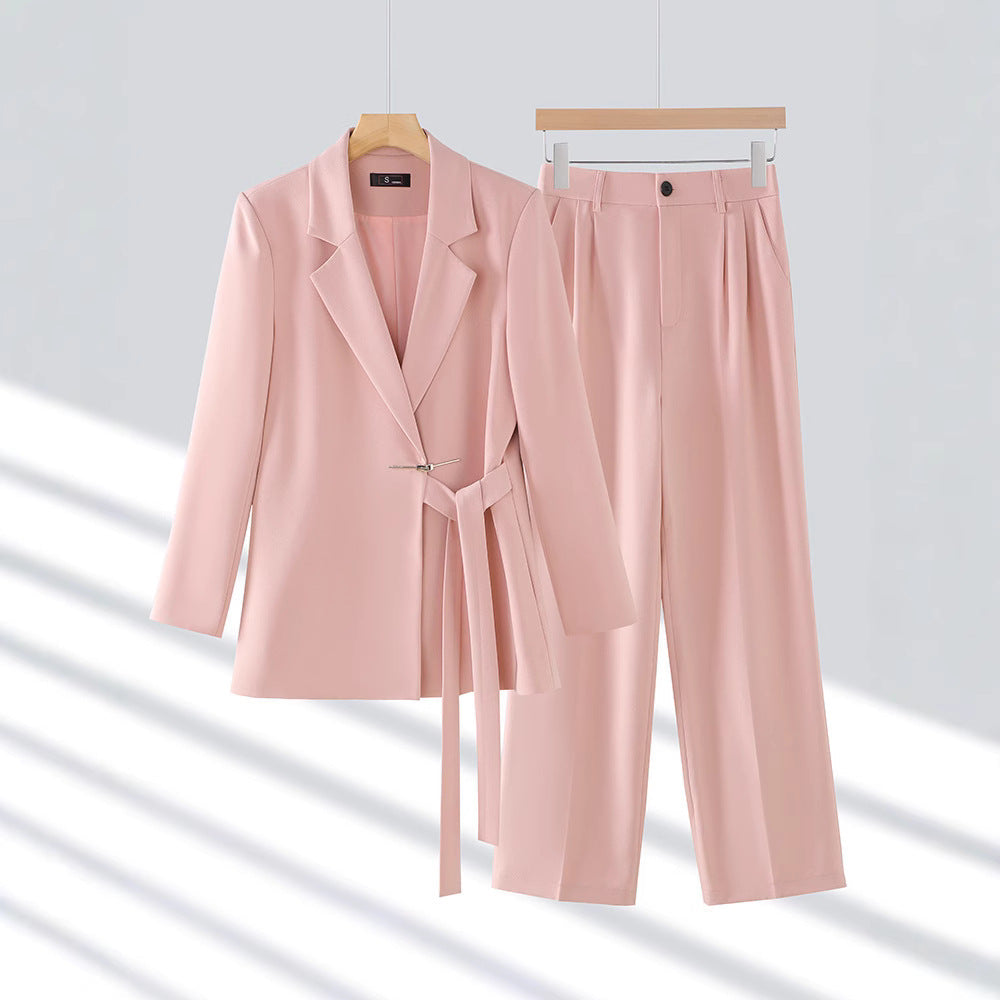 Elegant women's tailored suit set with long blazer and trousers, perfect for business and formal wear.