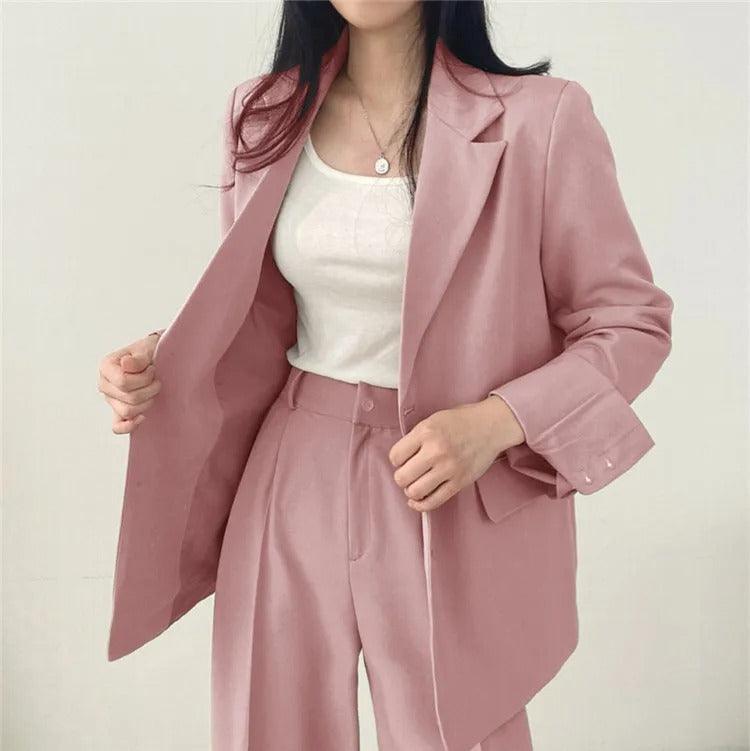 Women's power suit, a sophisticated long blazer and matching tailored trousers ensemble