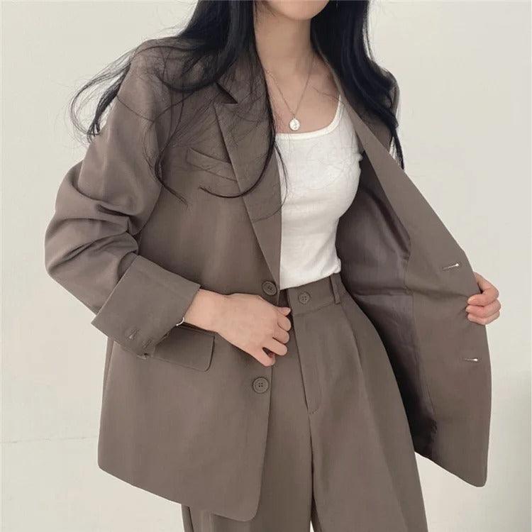 Power dressing: women's elegant tailored suit with a long blazer and sharp trousers