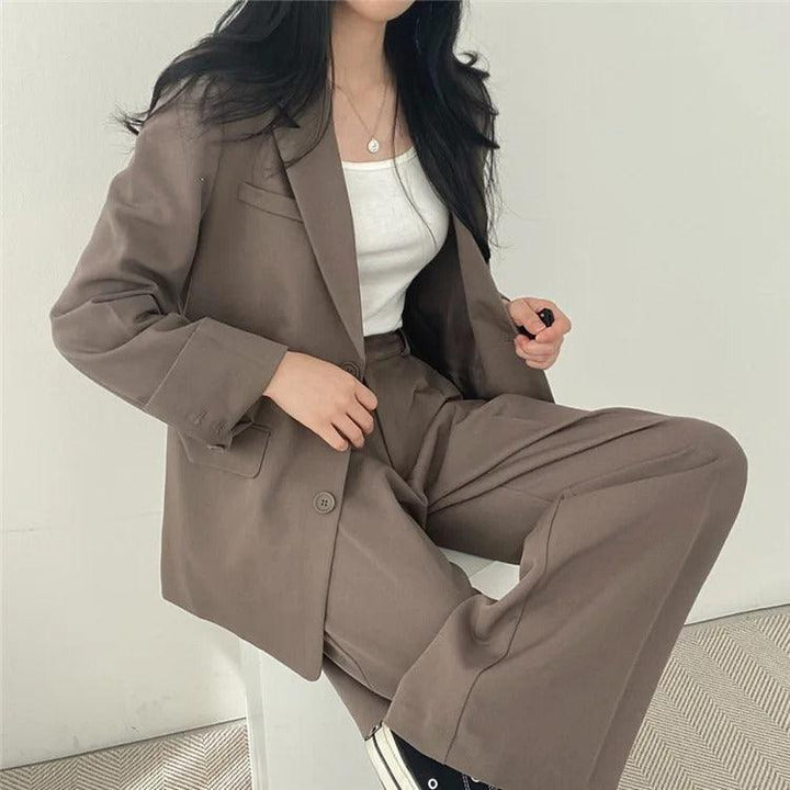 Elegant women's tailored suit set for work, featuring a long blazer and fitted trousers