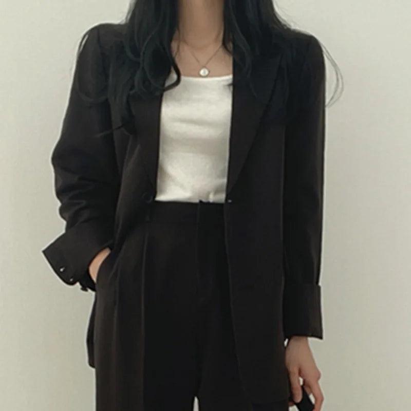 Professional and chic women's tailored suit with a long blazer and streamlined trousers