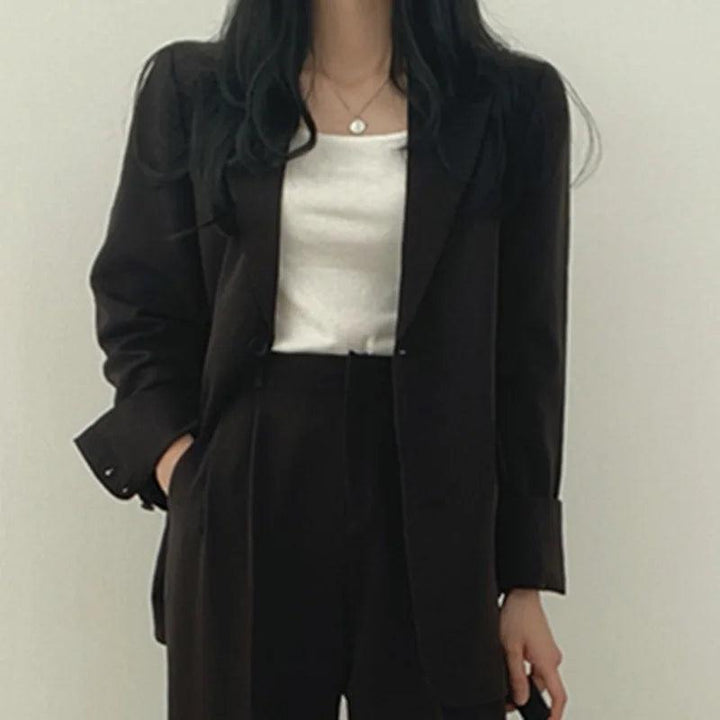 Professional and chic women's tailored suit with a long blazer and streamlined trousers