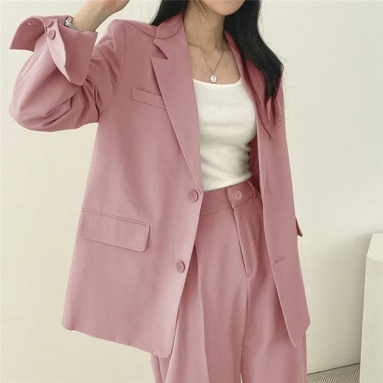 Office chic: women's elegant tailored suit with a long blazer and formal trousers