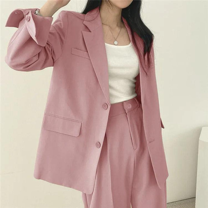 Office chic: women's elegant tailored suit with a long blazer and formal trousers