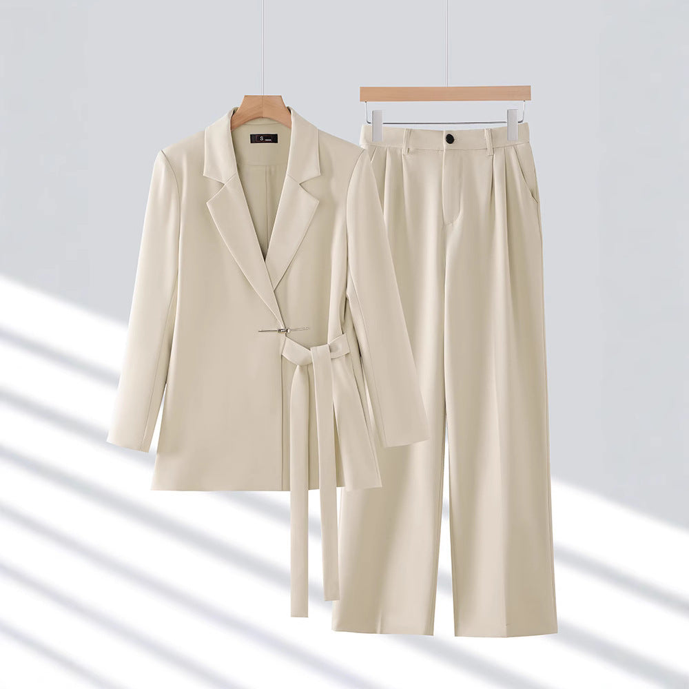 Women's formal wear: a long tailored blazer and matching trousers for a chic and professional outfit.