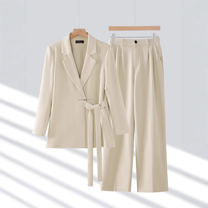 Women's formal wear: a long tailored blazer and matching trousers for a chic and professional outfit.