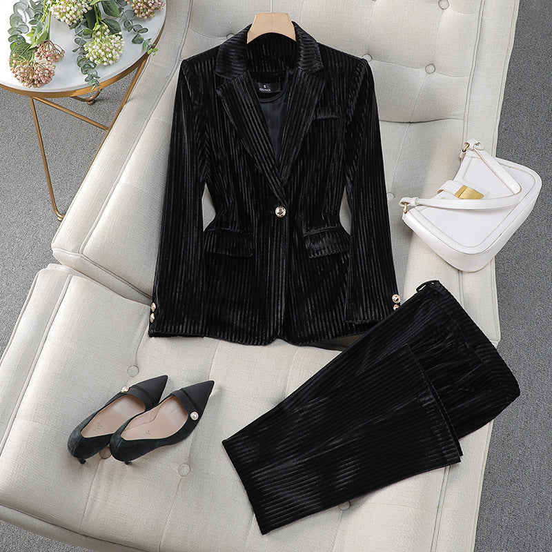 Modern women's tailored suit set with a long blazer and matching trousers for an elegant, professional style.