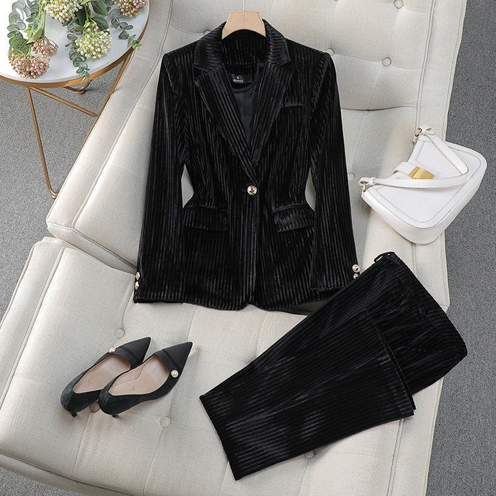 Modern women's tailored suit set with a long blazer and matching trousers for an elegant, professional style.