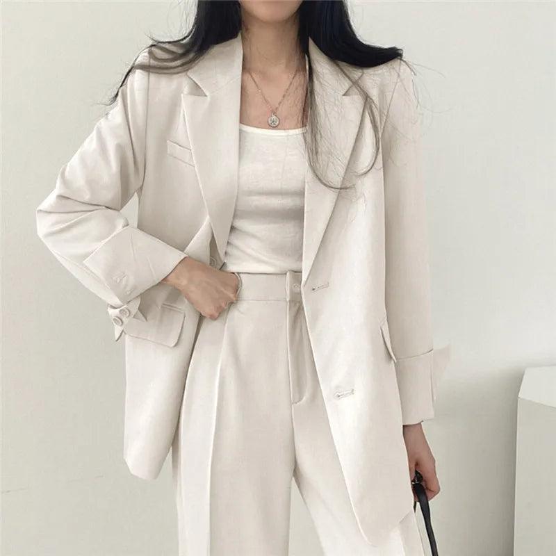 Sophisticated women's tailored suit with a flowing long blazer and classic trousers