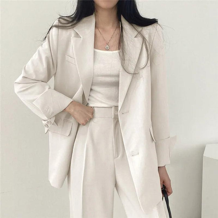 Sophisticated women's tailored suit with a flowing long blazer and classic trousers