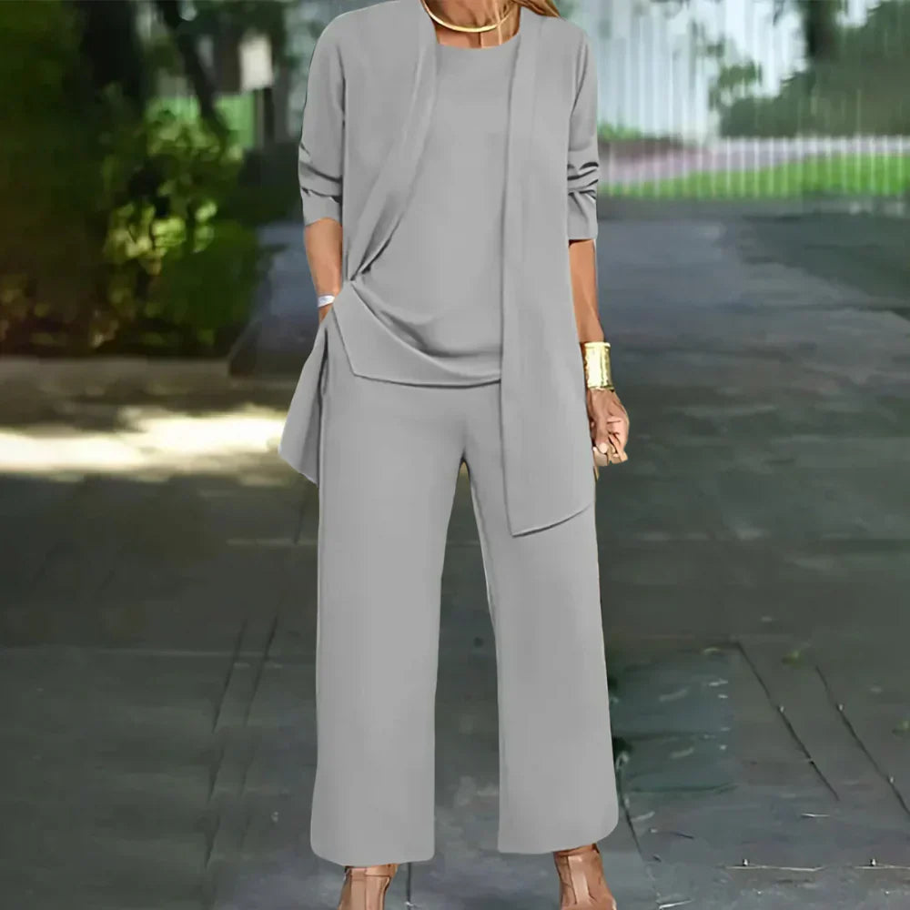 Stylish women's tailored three-piece suit. Includes a fitted blazer, matching vest, and straight-leg pants.