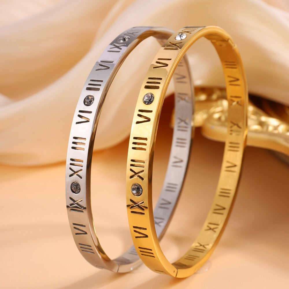 Elegant women's titanium bracelet featuring gold-tone Roman numerals, a timeless fashion jewelry accessory.