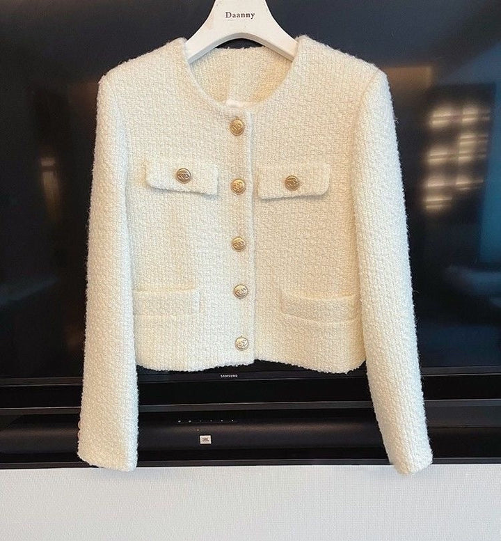 Elegant women's tweed jacket with a timeless round neck design, perfect for sophisticated ladies' fashion.