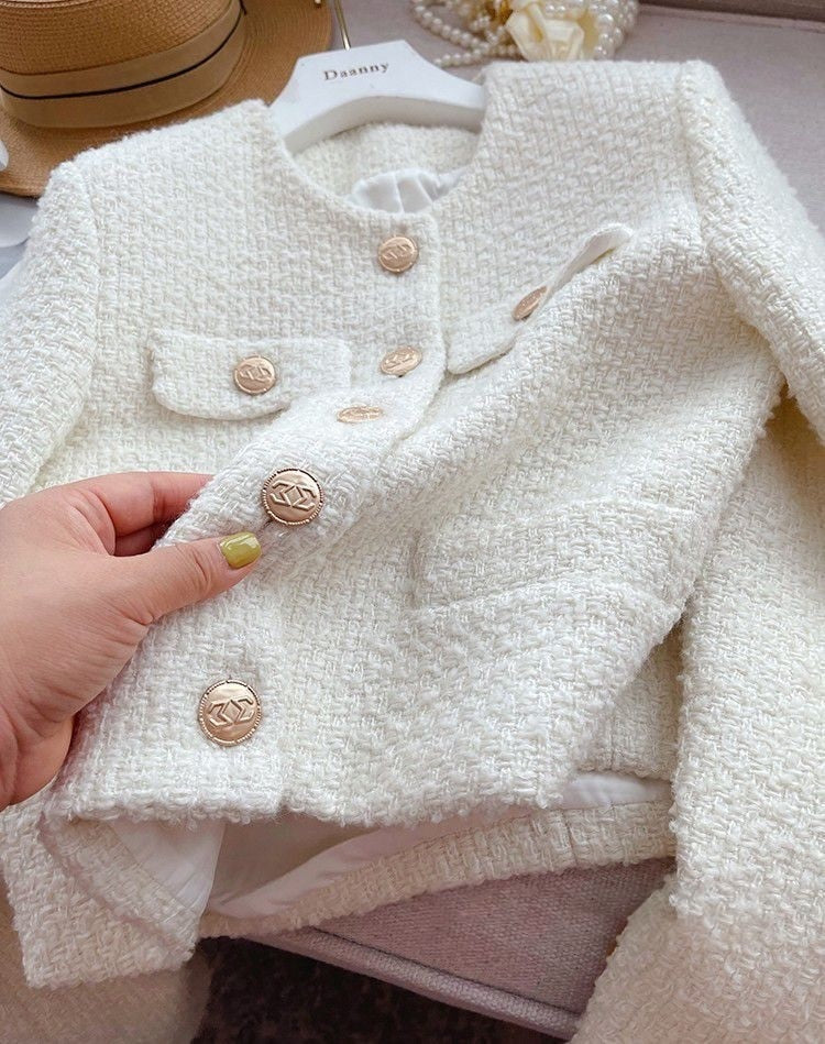 Sophisticated women's round neck tweed jacket, offering a timeless and elegant style for ladies.