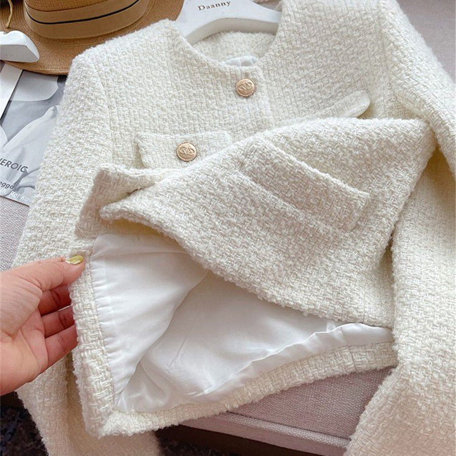 Stylish women's round neck tweed jacket, versatile and sophisticated for a casual chic ensemble.