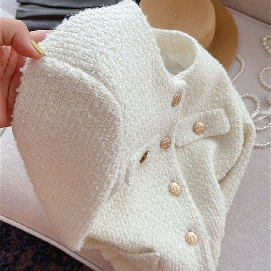 Women's classic tweed jacket with round neck, elegant outerwear that's timeless for ladies' fashion.