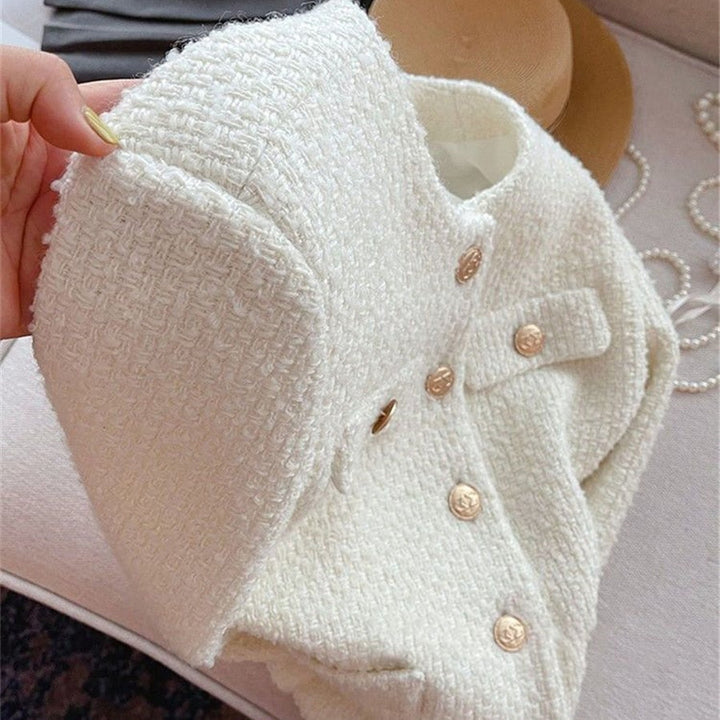 Women's classic tweed jacket with round neck, elegant outerwear that's timeless for ladies' fashion.