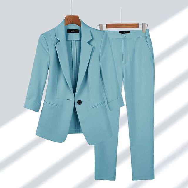 Stylish women's formal blazer and trousers set, perfect for professional work attire and elegant occasions.