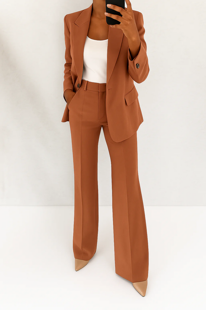 Sophisticated women's tailored blazer, part of an elegant two-piece suit, designed for office professionalism.