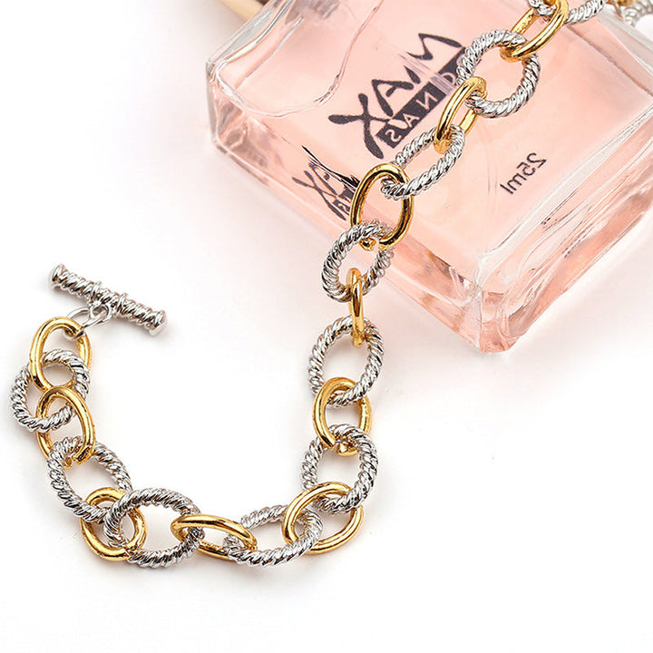 Luxurious two-tone twisted knot bangle, a stunning stainless steel bracelet for women.