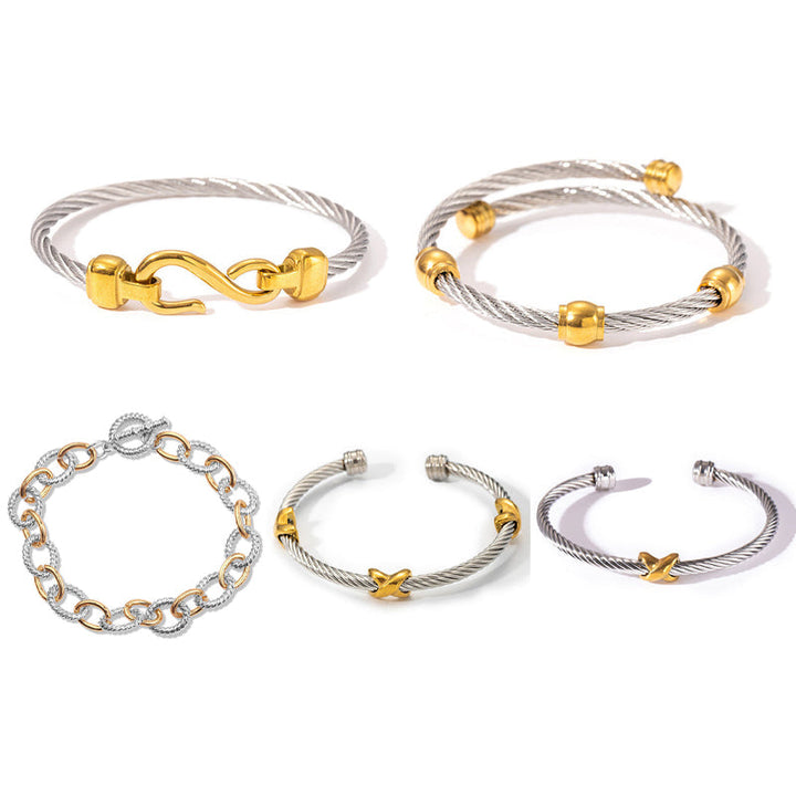 Hand modeling a women's two-tone knot twisted bangle bracelet, showcasing its fit.