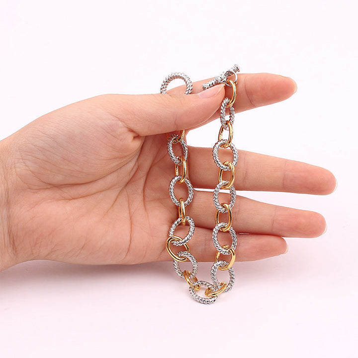 Delicate two-tone stainless steel knot bangle, a must-have jewelry accessory for women.