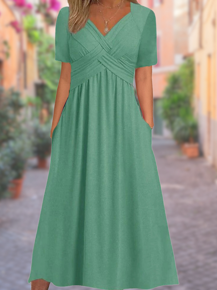 Fashionable women's midi dress featuring a flattering V-neckline and unique crisscross bodice detail.