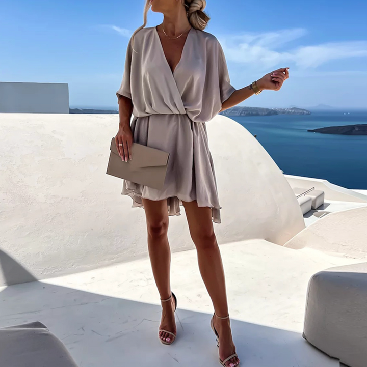 Graceful women's V-neck wrap mini dress. Flowy design, perfect for a stylish summer brunch or evening wear.