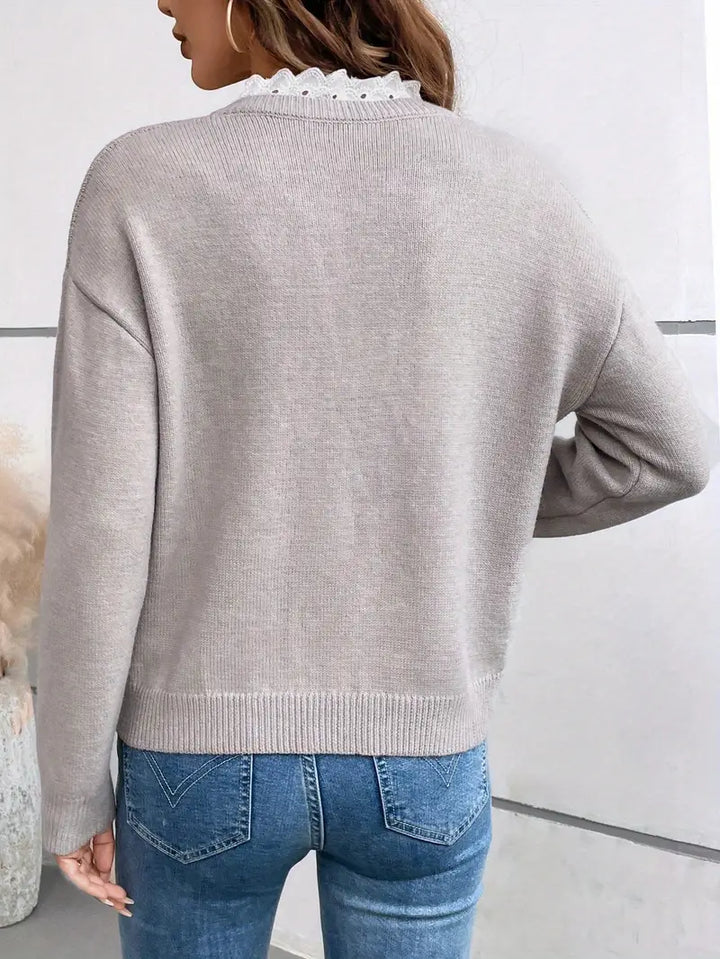 Soft women's pullover sweater with elegant lace-trim V-neck, a versatile piece for winter and fall fashion.