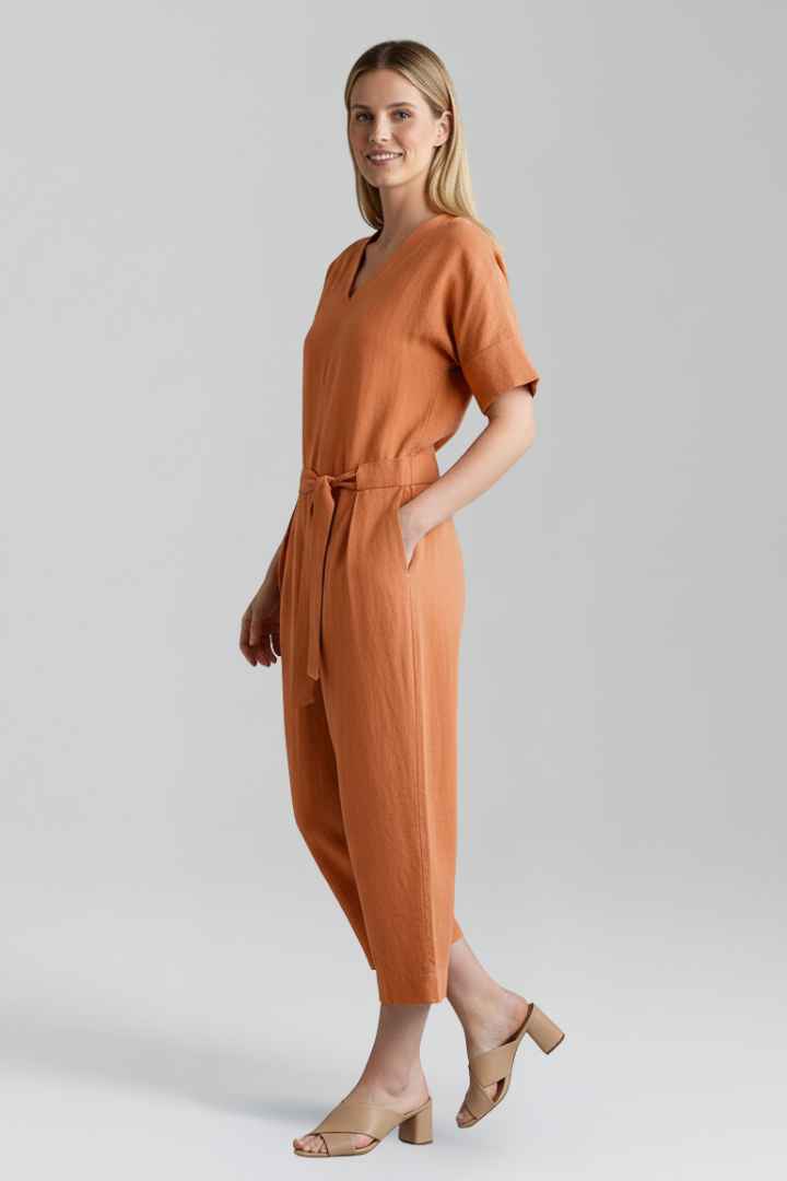 Comfortable pull-on women's jumpsuit with a modern V-neck, wide leg, and stylish waist tie detail.