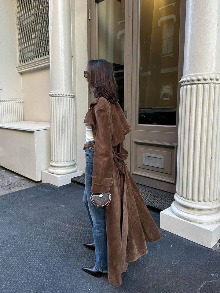 Stylish women's warm brown trench coat with belt, a versatile and elegant outerwear piece.