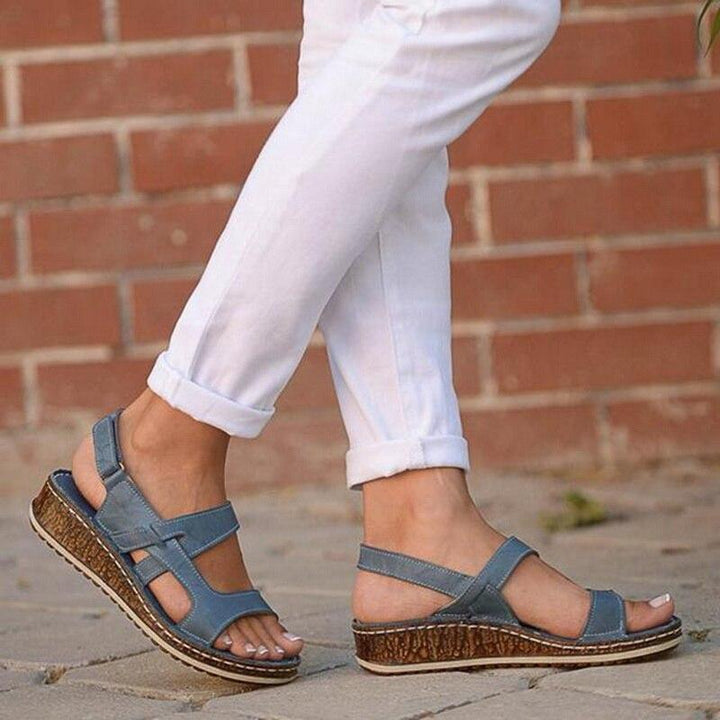Chic women's wedge sandals, ideal for elegant summer outfits. Comfortable open-toe footwear fashion.
