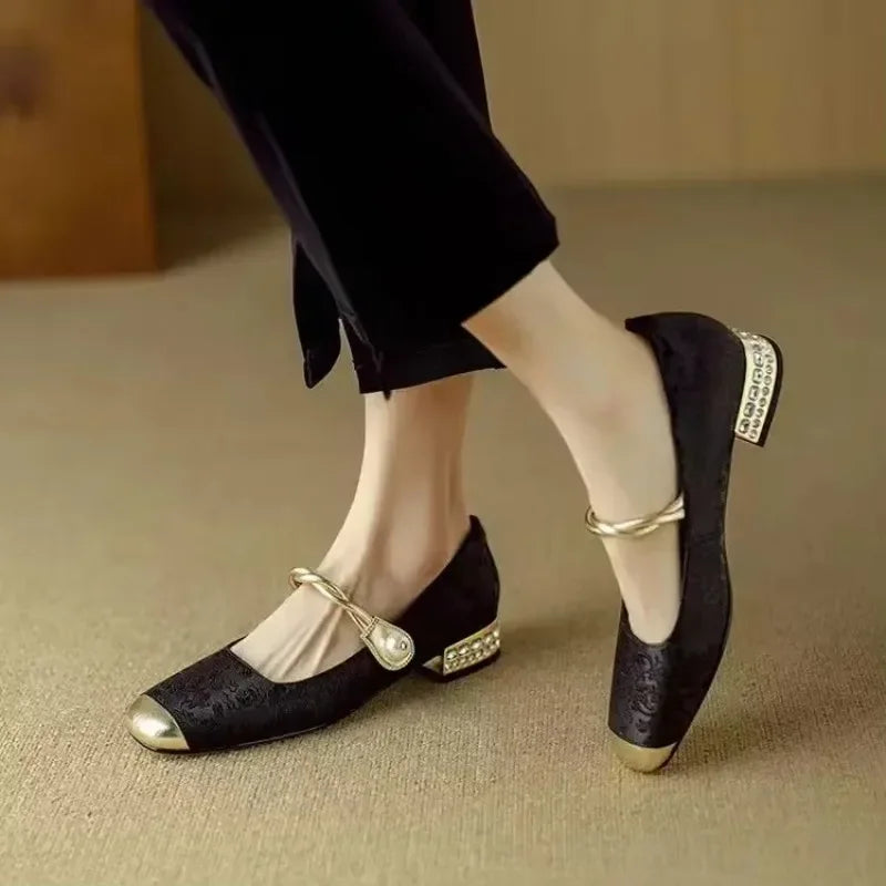 Fashionable women's flats with pearl detailing and a shimmering metallic cap-toe.