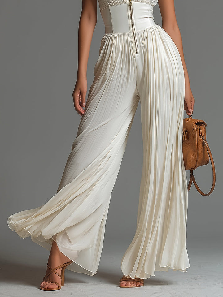 Formal white pleated jumpsuit for women. Features a deep V-neck, wide-leg, and elegant pleated details.