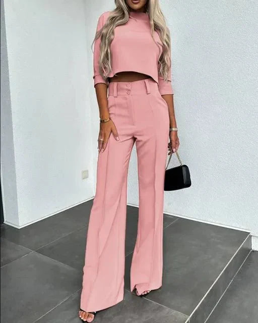 Women's cropped top and tailored trousers in a matching elegant fabric, ideal for stylish events.