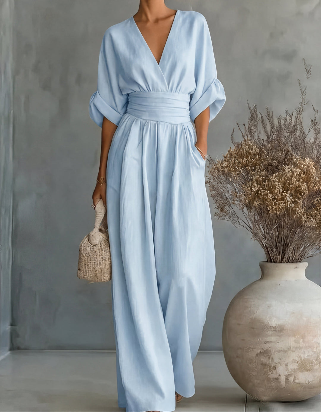 Full length view of elegant wide-leg wrap-front jumpsuit for women, showcasing its relaxed fit.