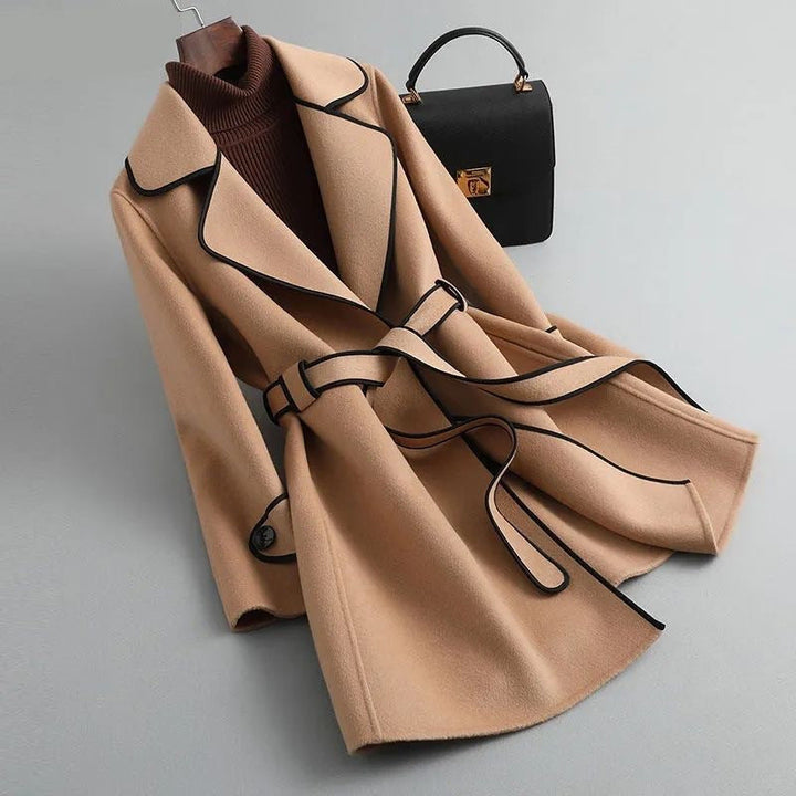 Fashionable women's winter coat: longline, wool-blend, belted, offering an elegant silhouette