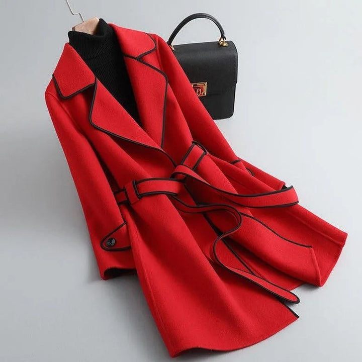 Side profile of a women's longline wool-blend coat with a flattering belt and prominent piping