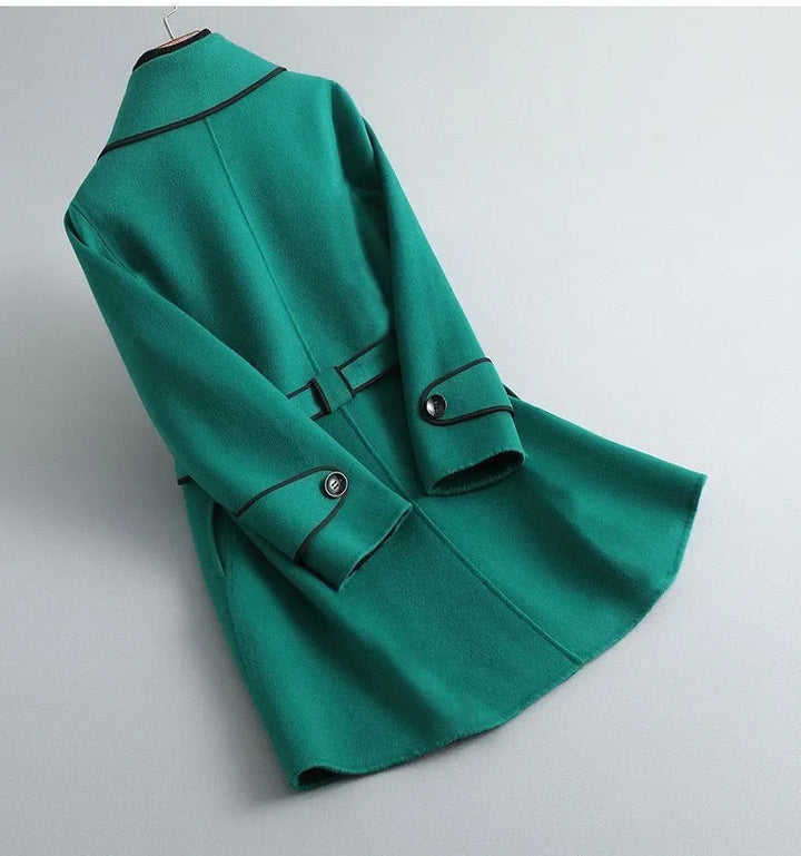 Full-length shot of an elegant women's belted wool-blend longline coat with stylish contrast piping