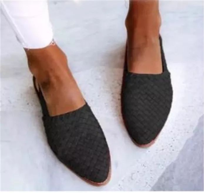 Chic black woven mules for women, featuring a pointed toe and slip-on flat design. Versatile elegant footwear.
