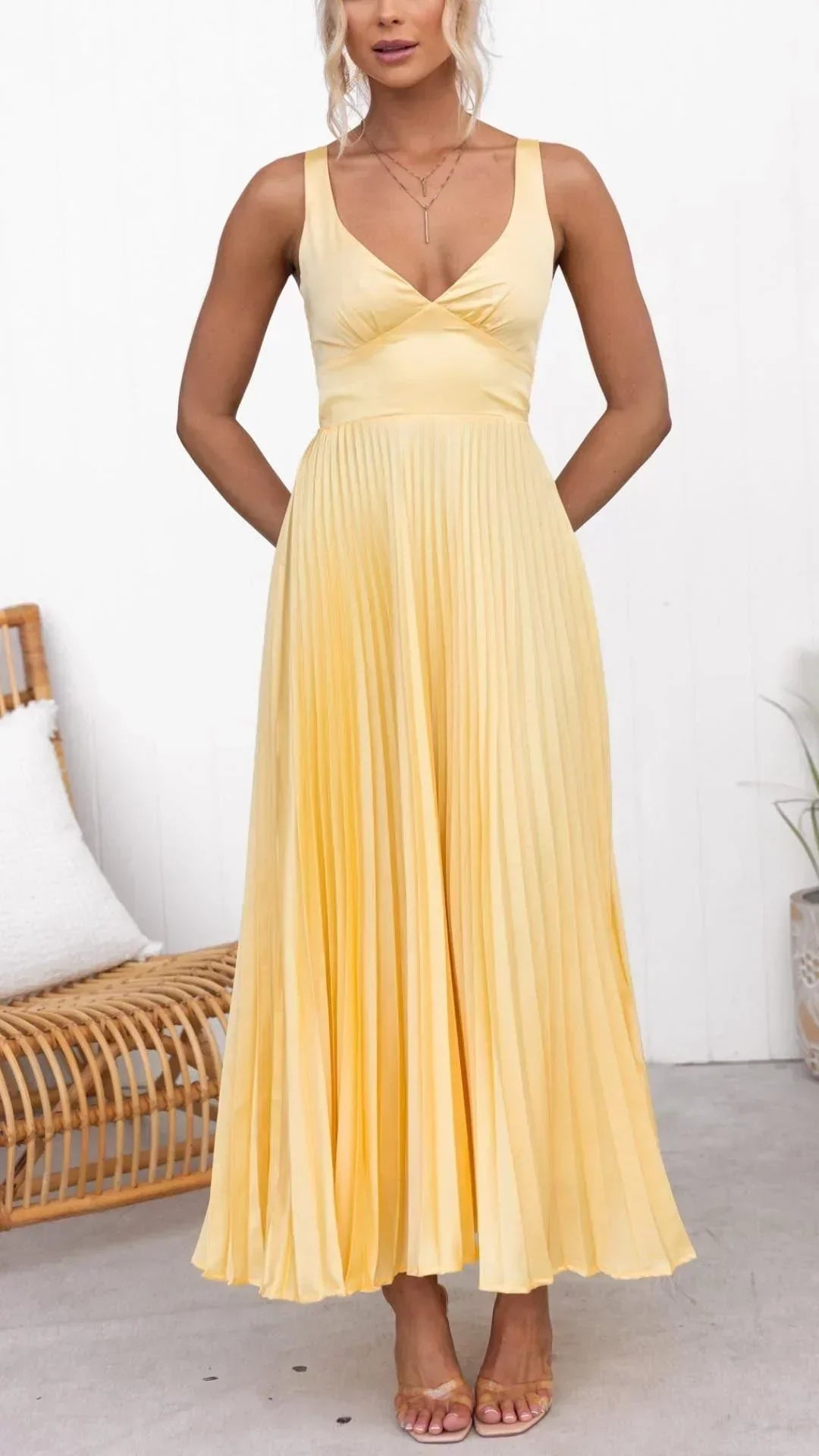 Close-up of the V-neck and pleats on a stylish yellow women's maxi dress