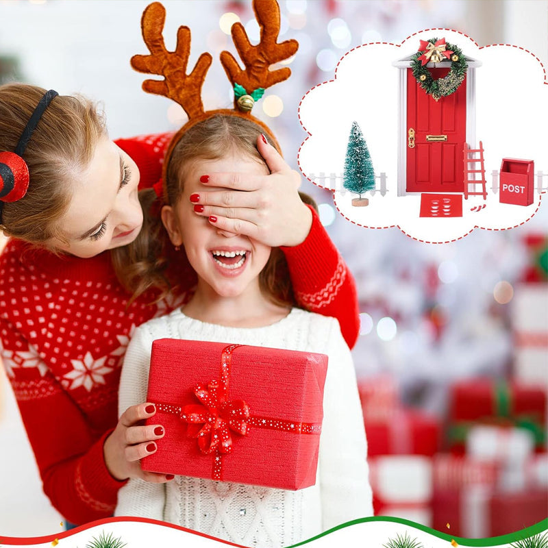 Child's hand placing a miniature elf door decoration, adding magic to holiday festivities