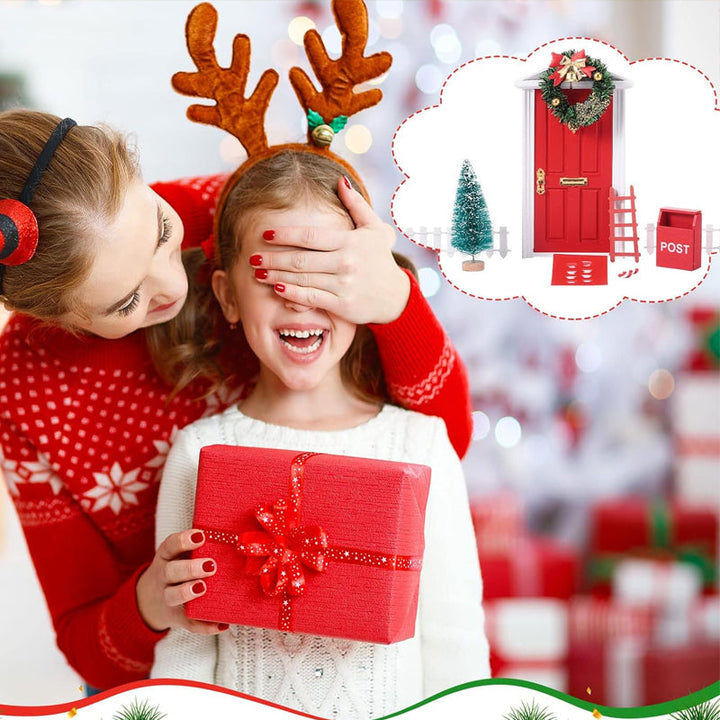 Child's hand placing a miniature elf door decoration, adding magic to holiday festivities