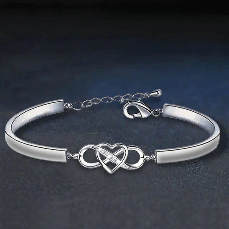 Close-up of engraved heart on a women's rose gold bracelet, ideal for Mother's Day.
