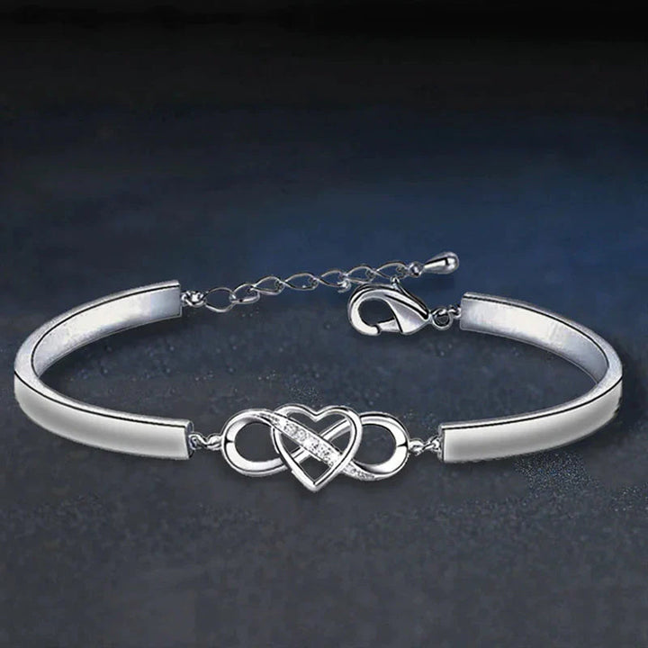 Close-up of engraved heart on a women's rose gold bracelet, ideal for Mother's Day.