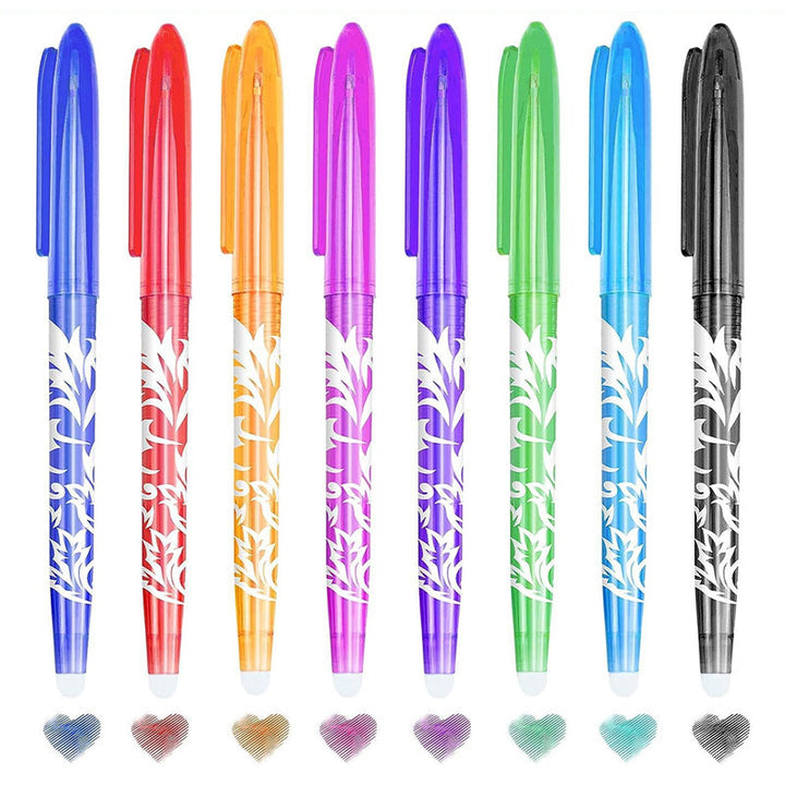 Various colored erasable gel pens scattered on a desk with notebooks, creative writing tools