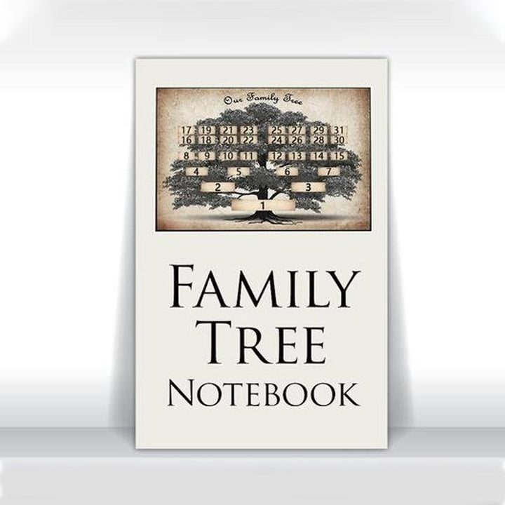 A hand writing in the Family Ancestry Keepsake Journal, personalizing the family tree notebook with ancestral details.
