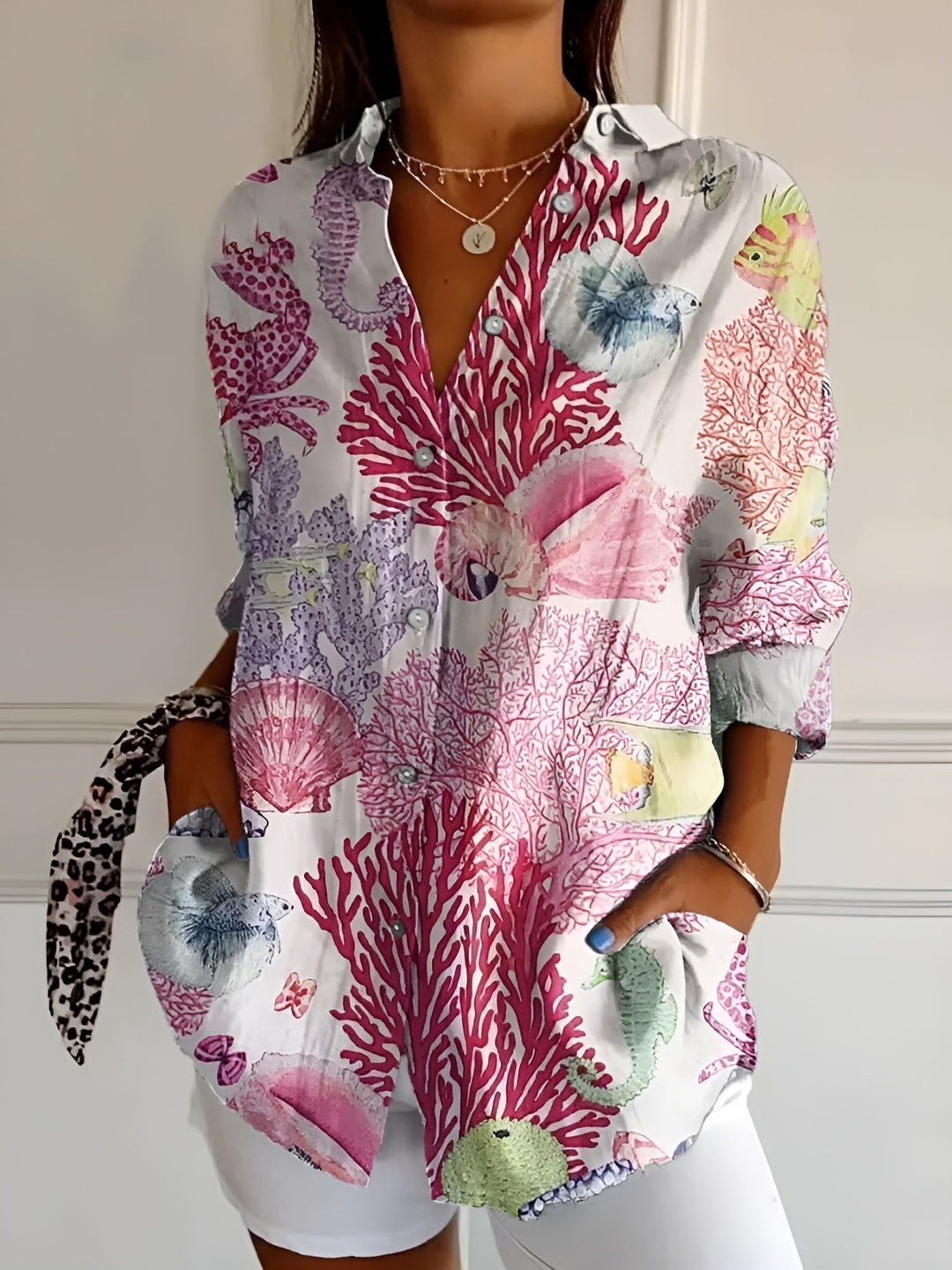 Lightweight summer women's printed top, button-front, three-quarter sleeves, and collar. Fashionable & comfortable.