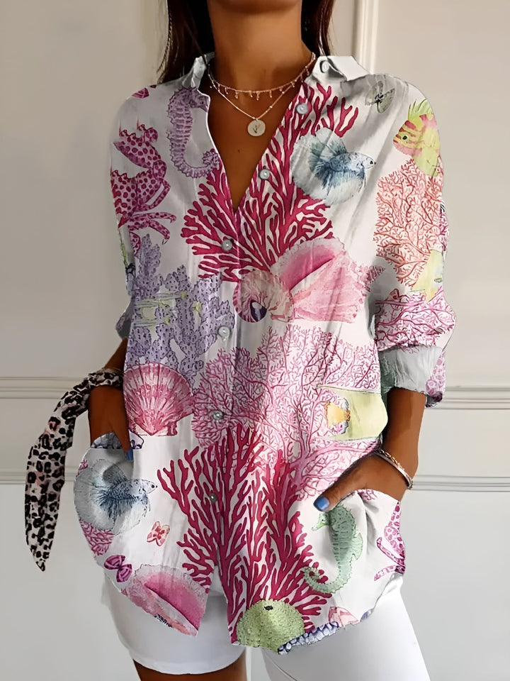 Lightweight summer women's printed top, button-front, three-quarter sleeves, and collar. Fashionable & comfortable.